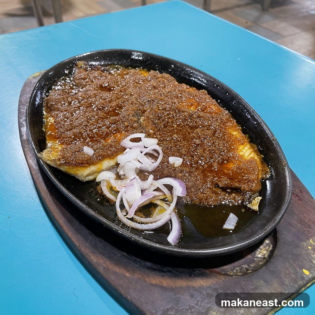 Sizzling Fish with Sauce and Onions