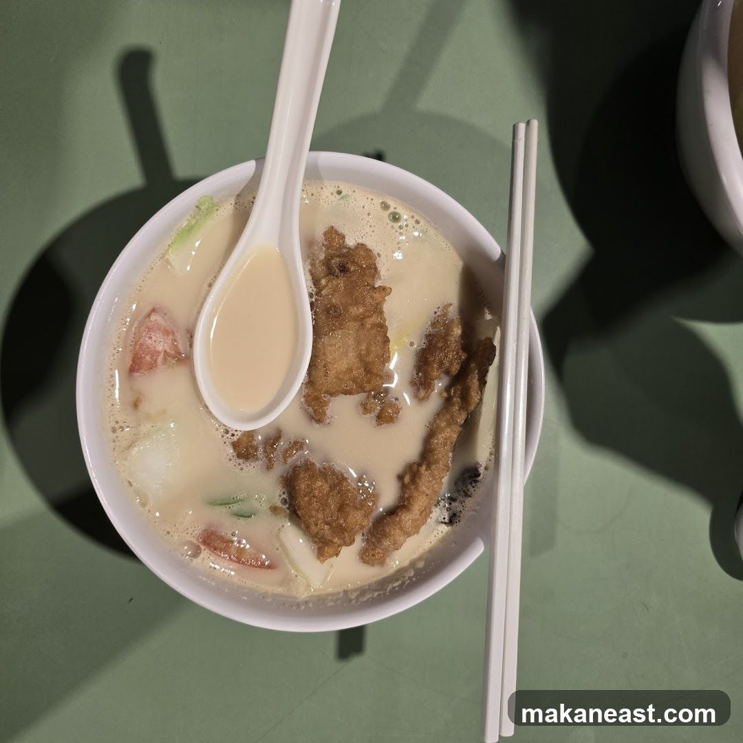 Bowl of Soup with Fried Fish