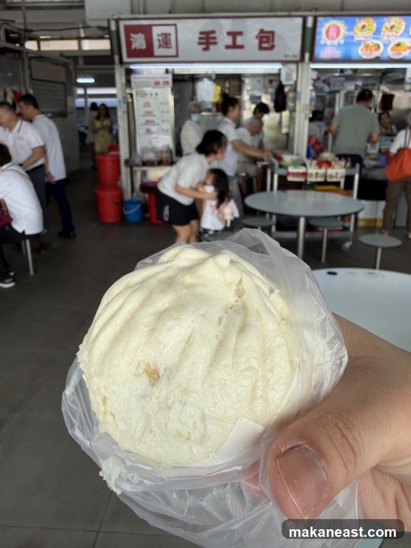 Hand holding a steamed bun
