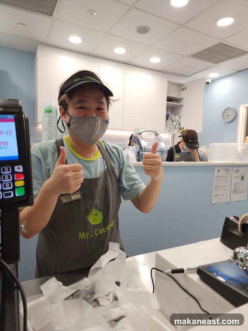Employee giving thumbs up at Mr. Coconut