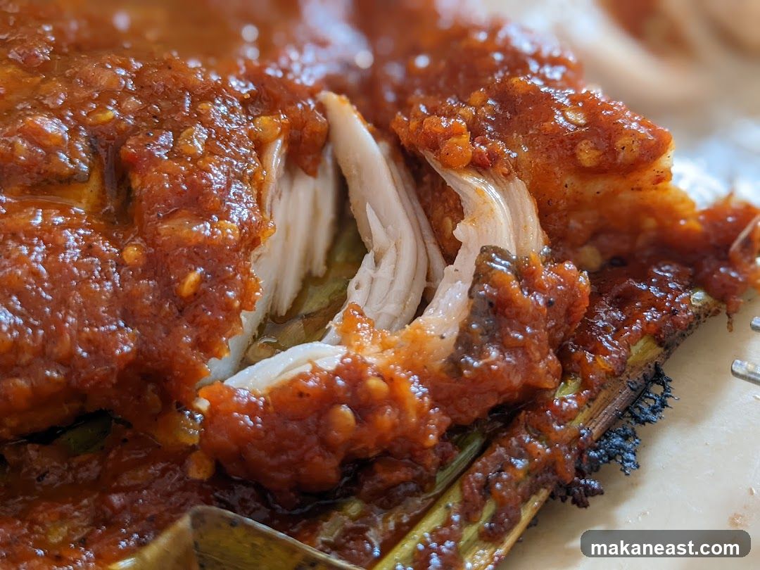 Close-up of grilled fish with chili sauce