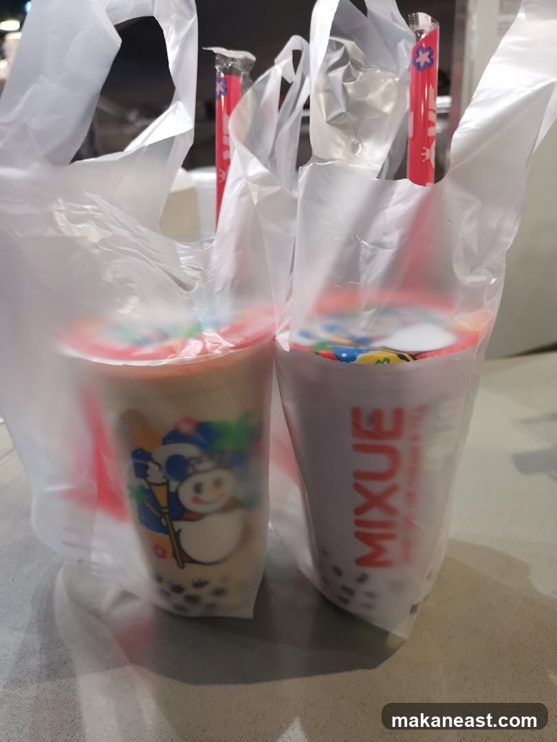 Two bubble tea drinks in plastic bags