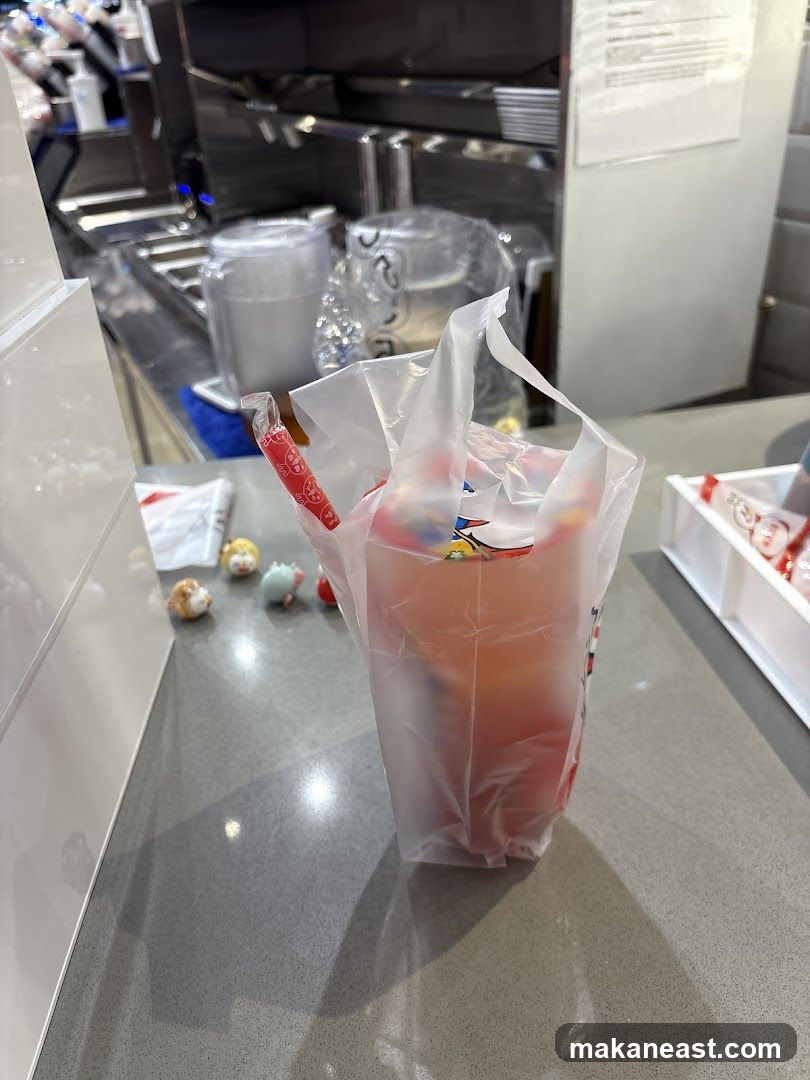 Drink in a plastic bag with straws and small figurines
