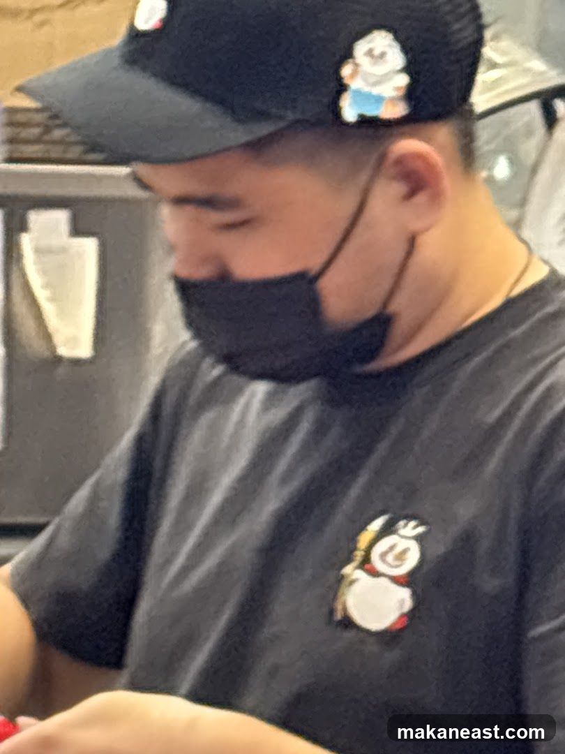 Person wearing a black t-shirt and black cap