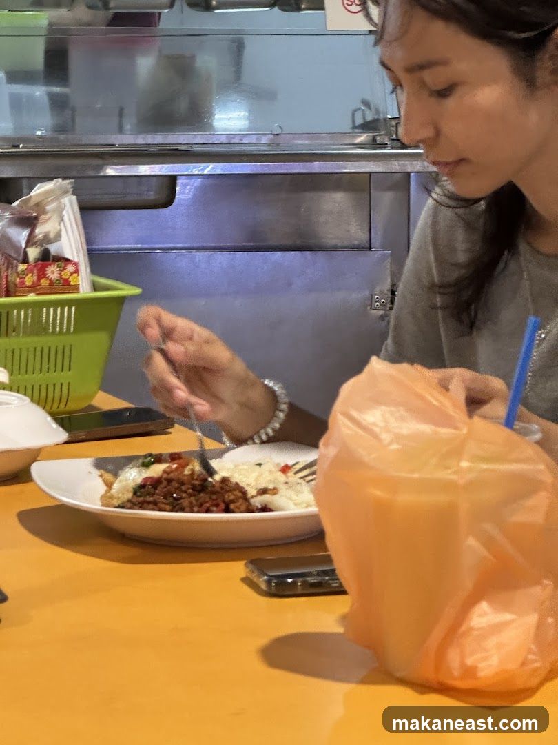 Woman eating at a food stall