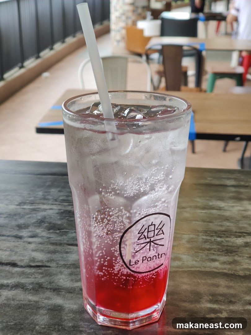 Red soda with ice and straw