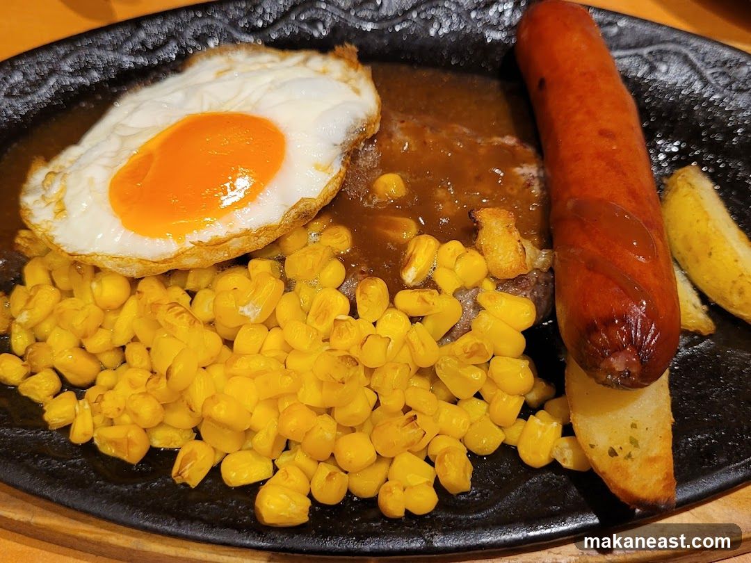 Steak with Fried Egg, Sausage, Corn, and Potatoes