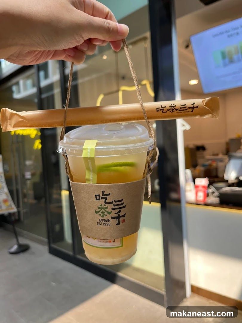 Drink with branded sleeve and straw