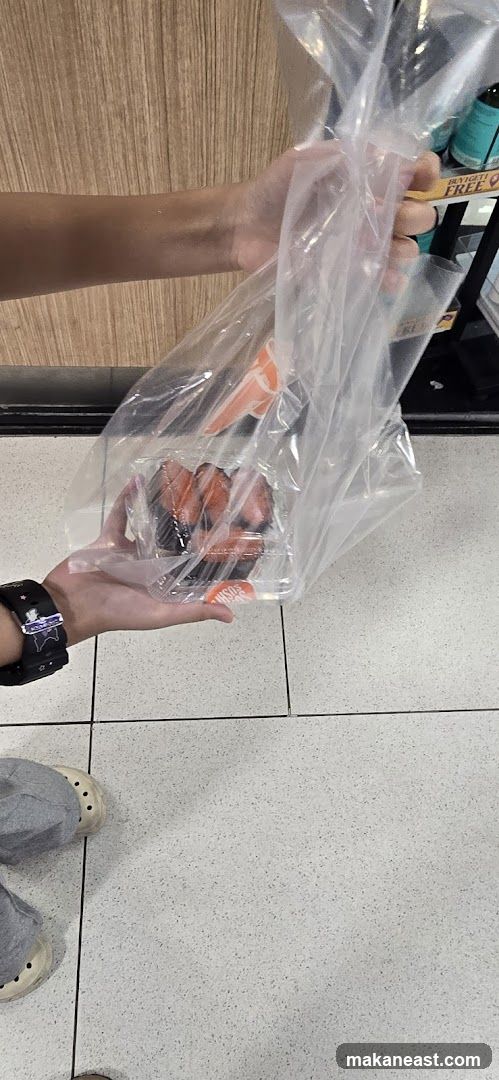 Person holding a bag of sushi