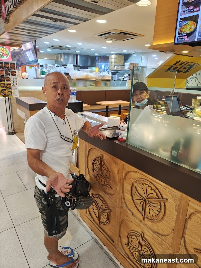 Man standing in front of a food stall