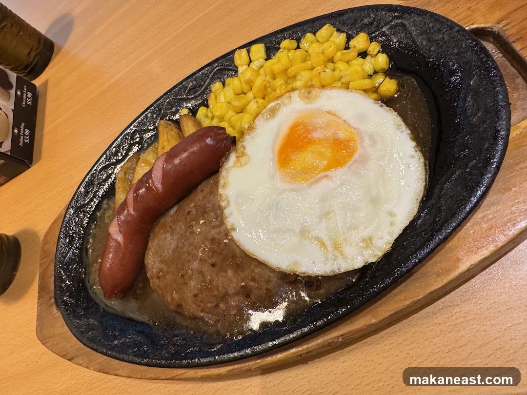 Sizzling Platter with Hamburger Steak, Sausage, and Fried Egg
