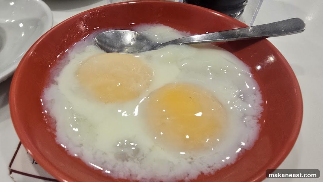 Soft-boiled eggs in a red bowl