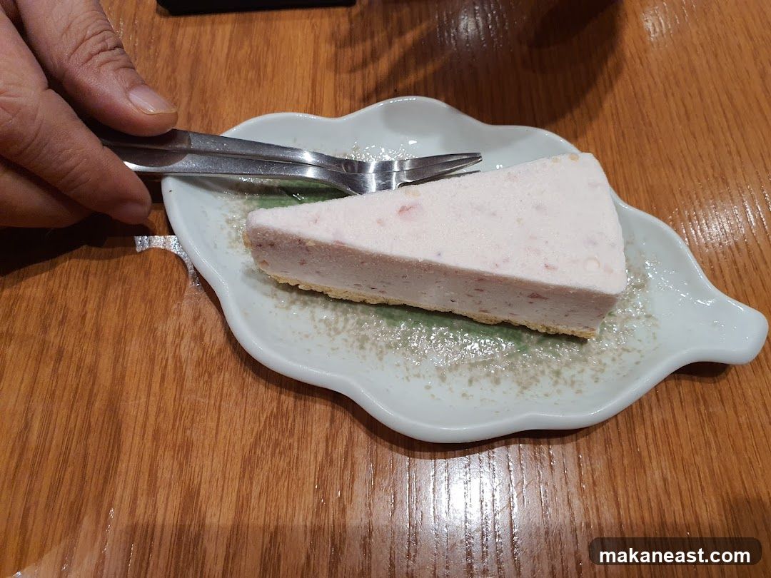 Slice of pink cheesecake on a leaf-shaped plate