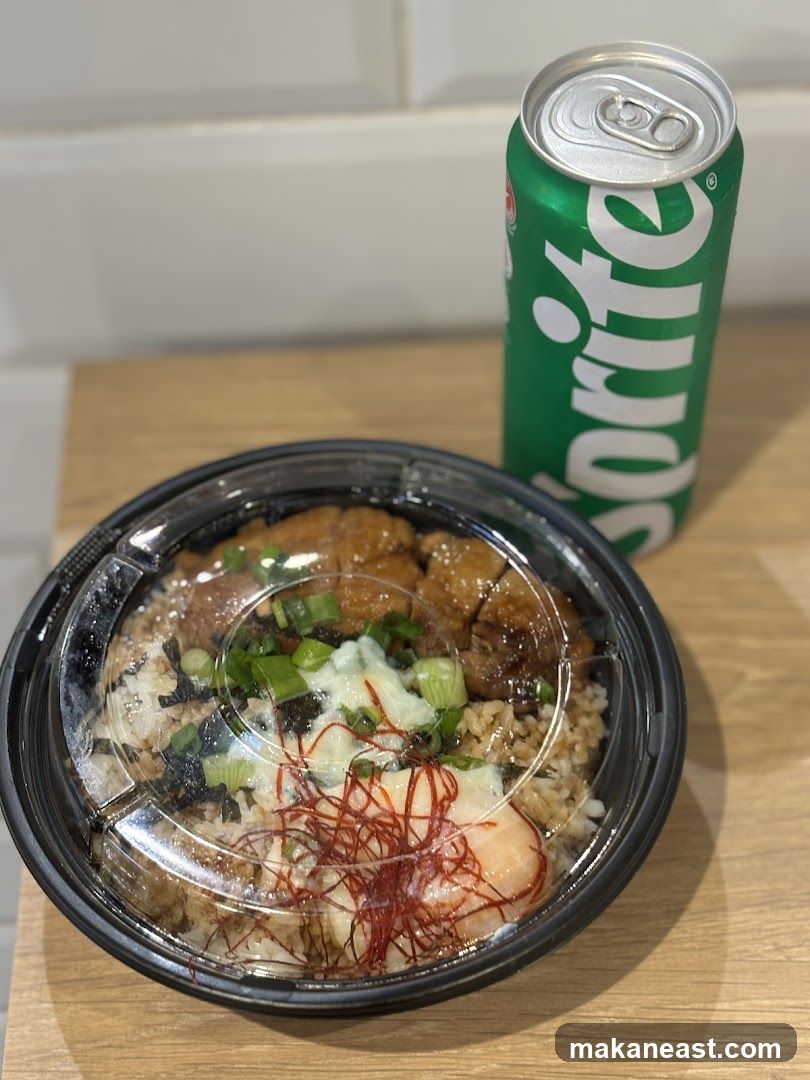 Rice bowl with chicken and a can of Sprite