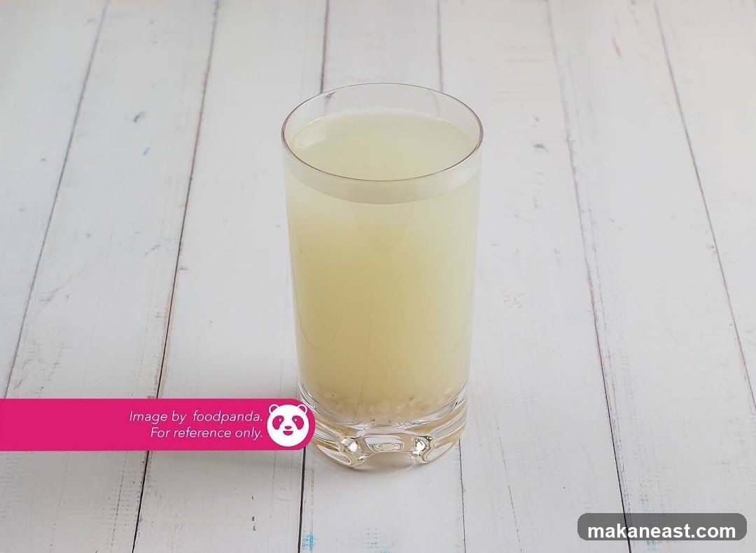 Glass of light-colored beverage