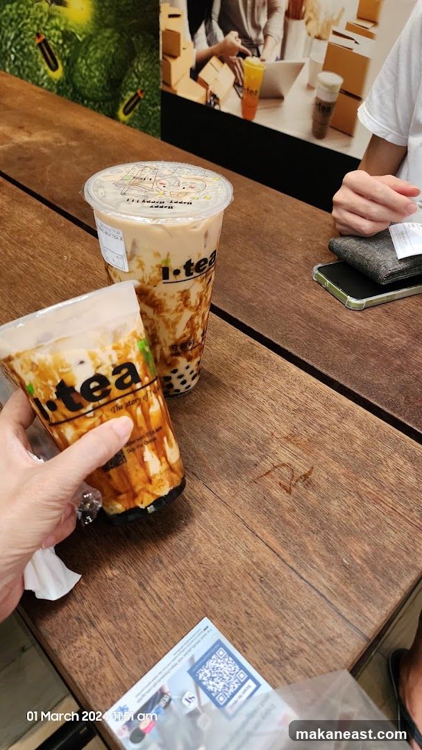 Two bubble tea drinks on a wooden table
