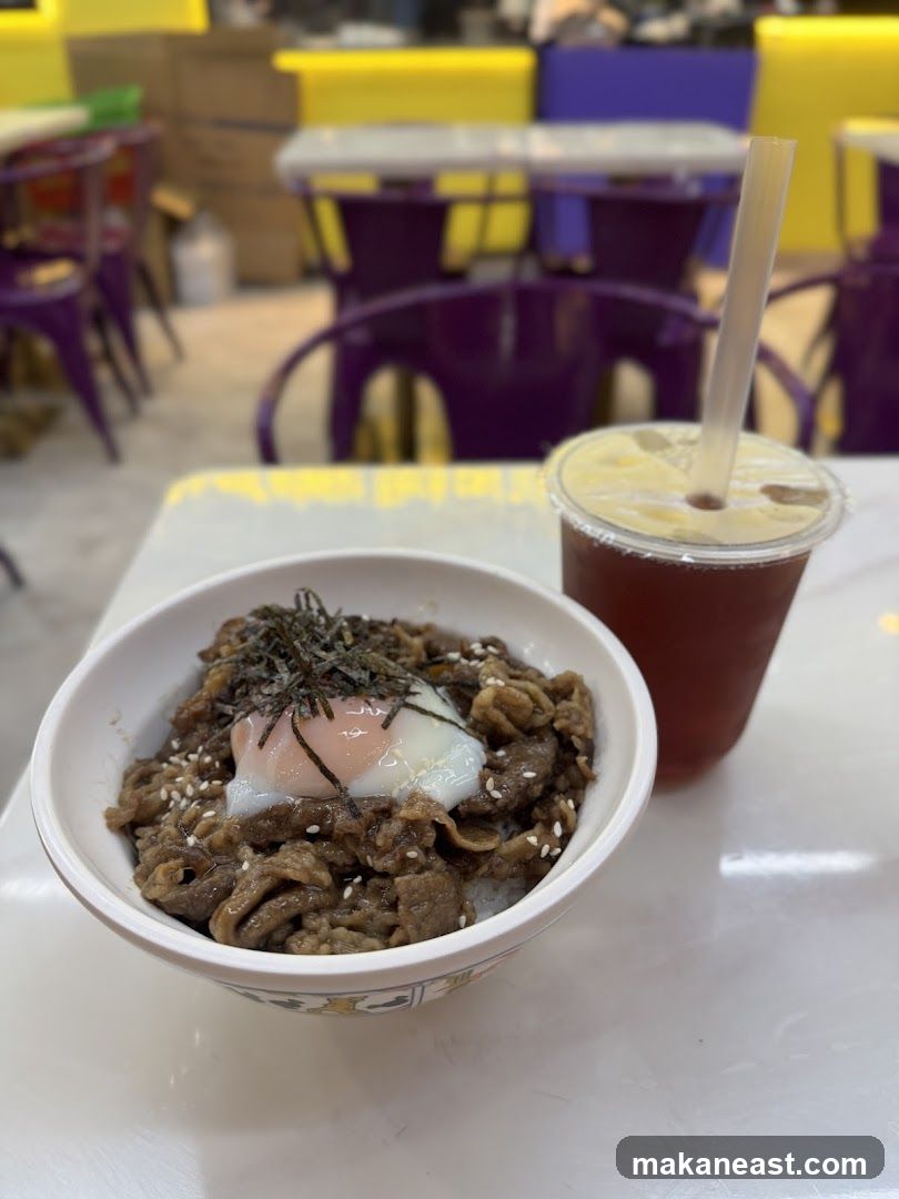 Beef bowl with egg and a drink