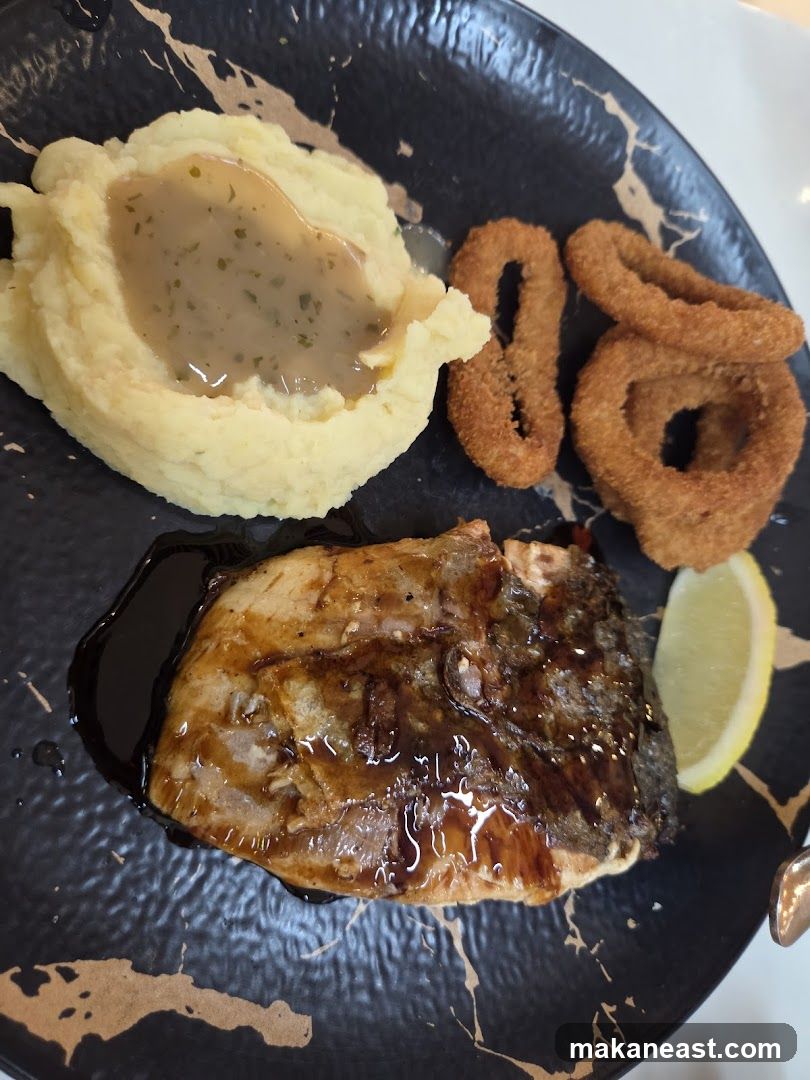 Fish dish with mashed potatoes and onion rings