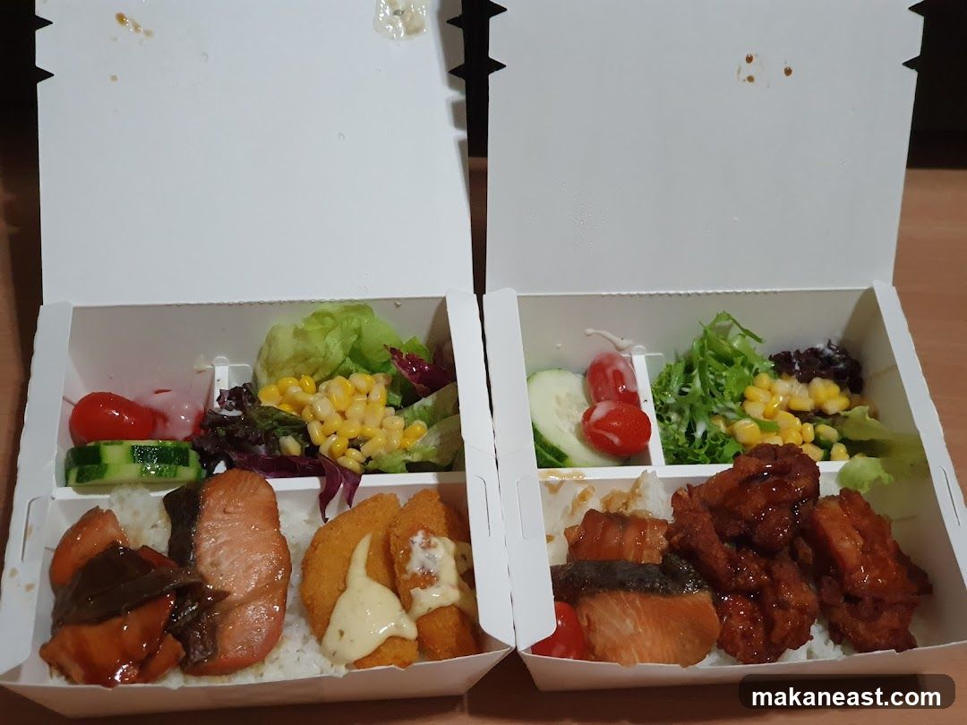 Two Bento Boxes with Salmon and Fried Chicken