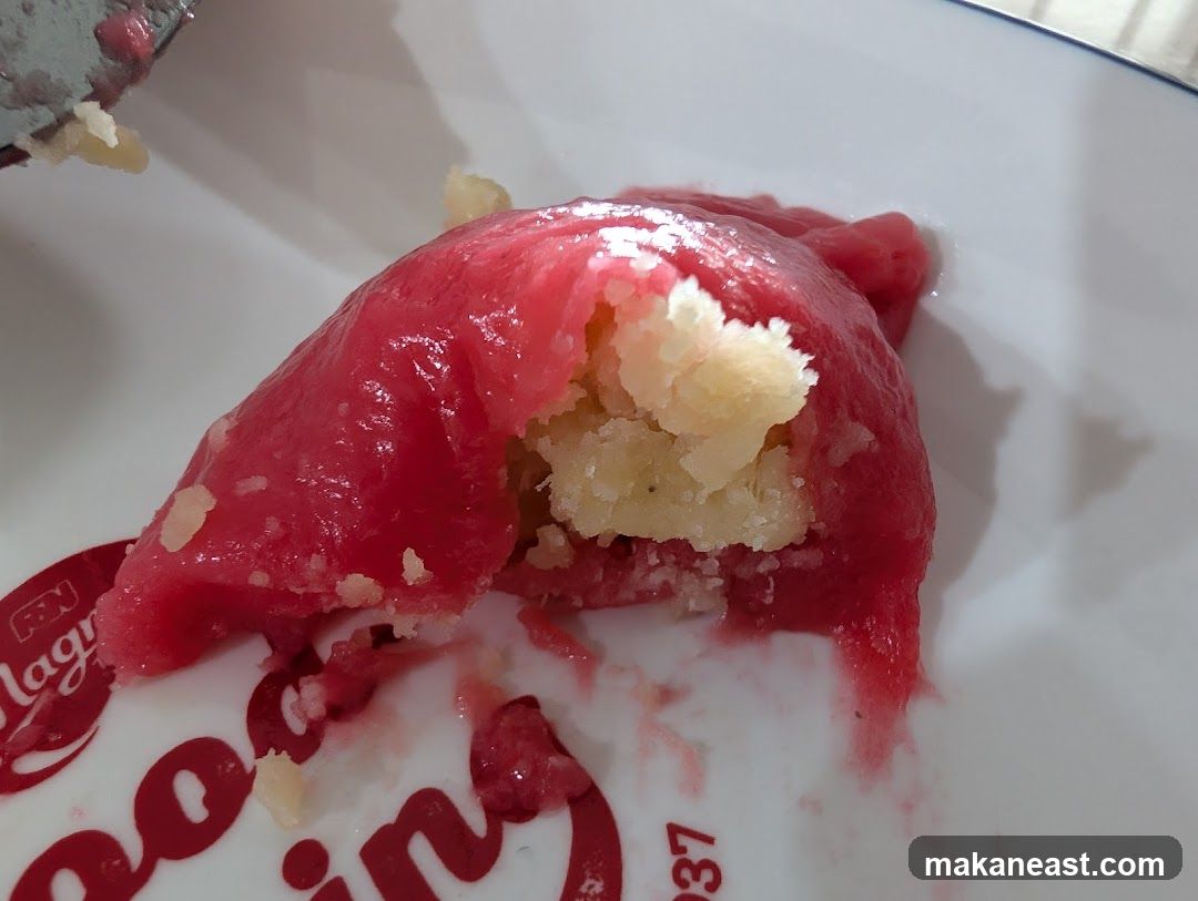 Close-up of a pink dessert with a creamy filling