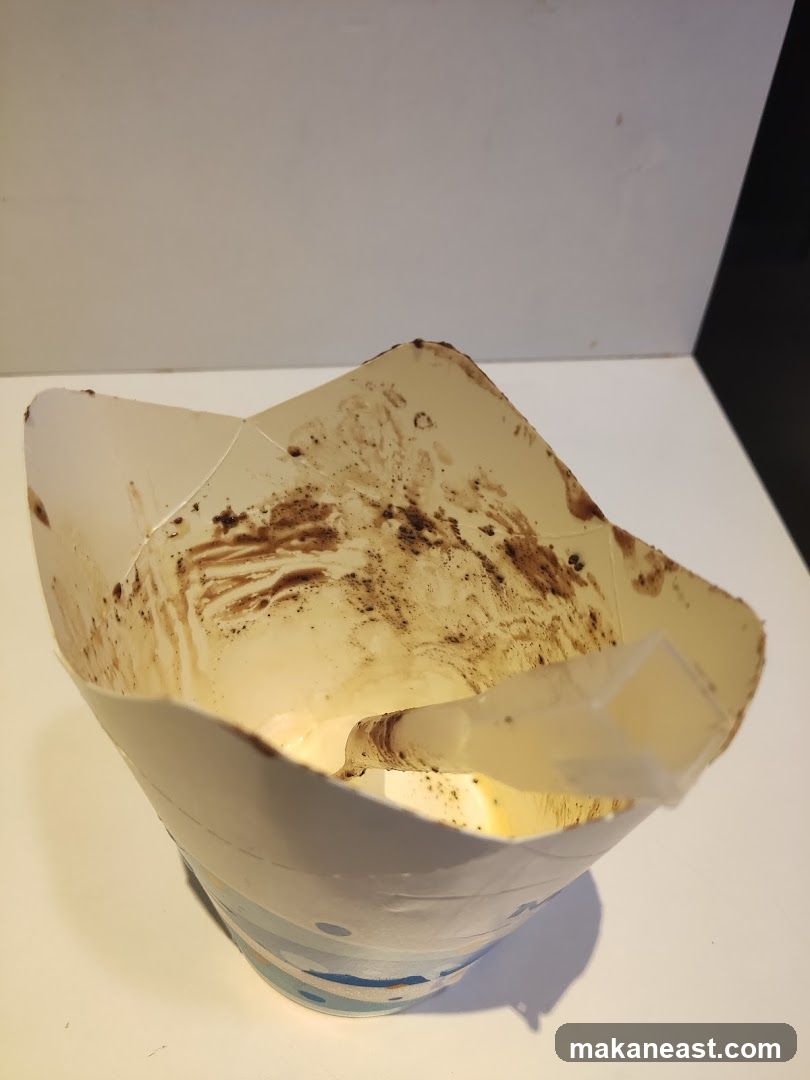 Empty coffee cup with straw