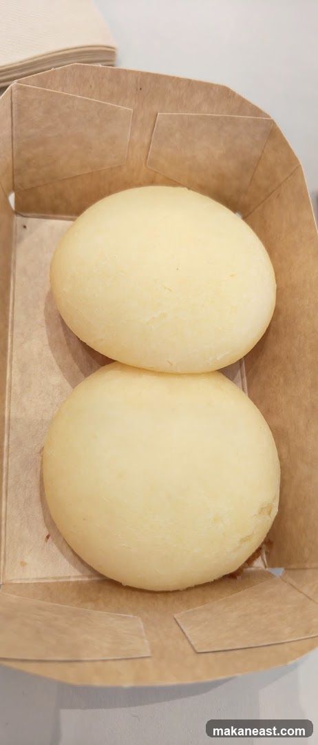 Two Pao de Queijo in a Box