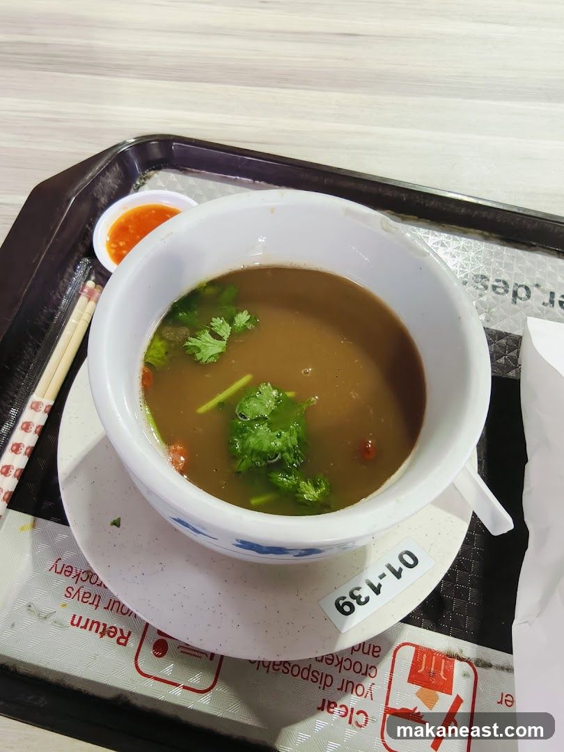 Soup with Chili Sauce and Chopsticks