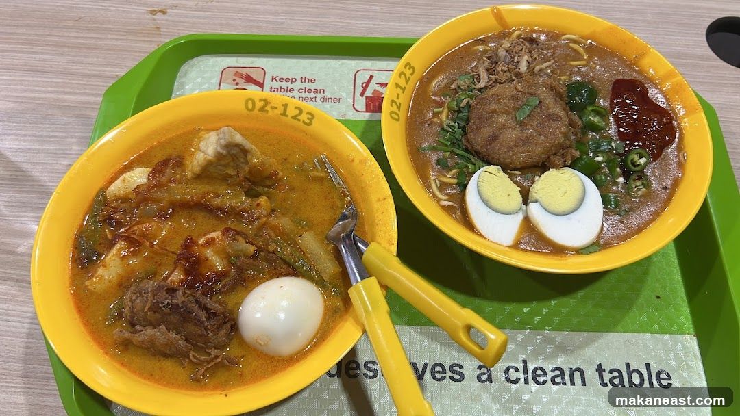 Two bowls of noodles on a tray