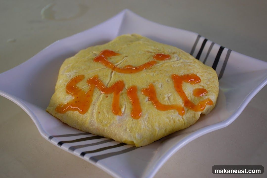 Omelet with "Smile" written in sauce