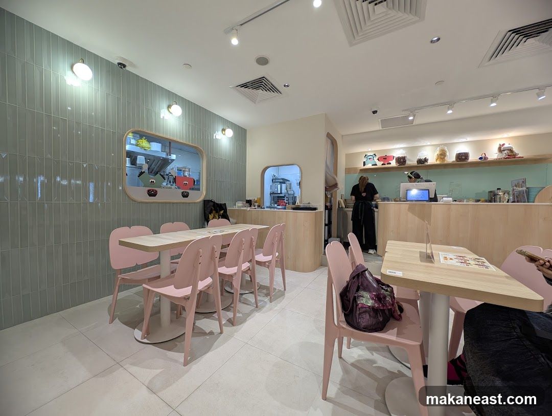 Cafe Interior with Pink Chairs and Wooden Counter