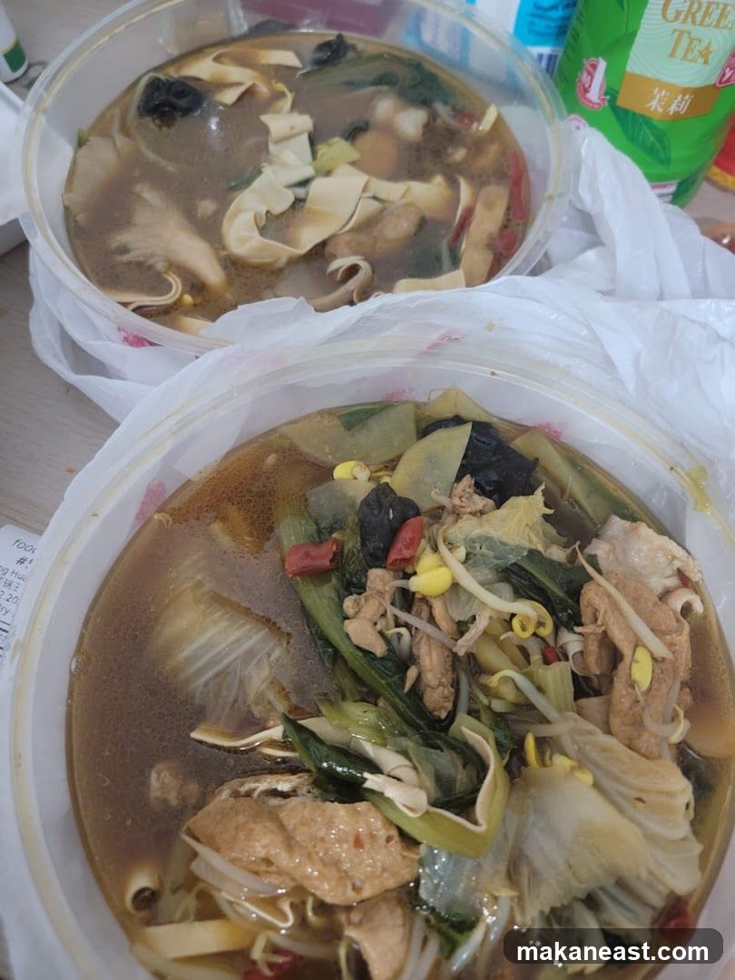 Two bowls of soup with vegetables and tofu