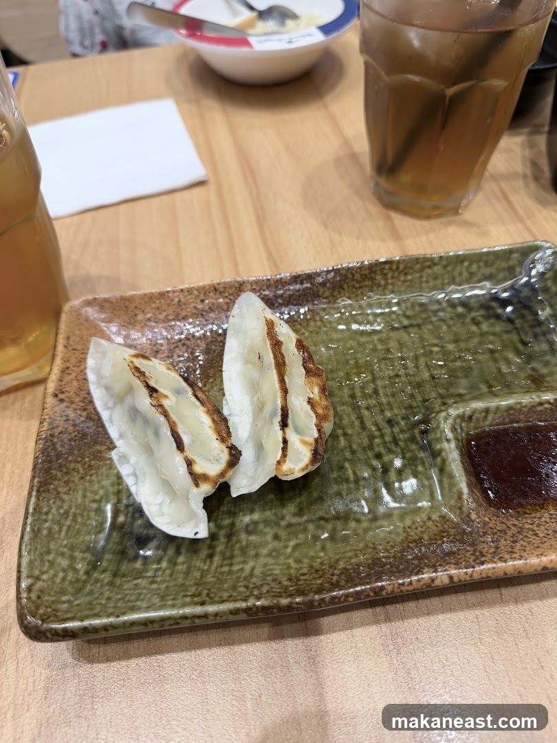 Pan-fried dumplings with dipping sauce