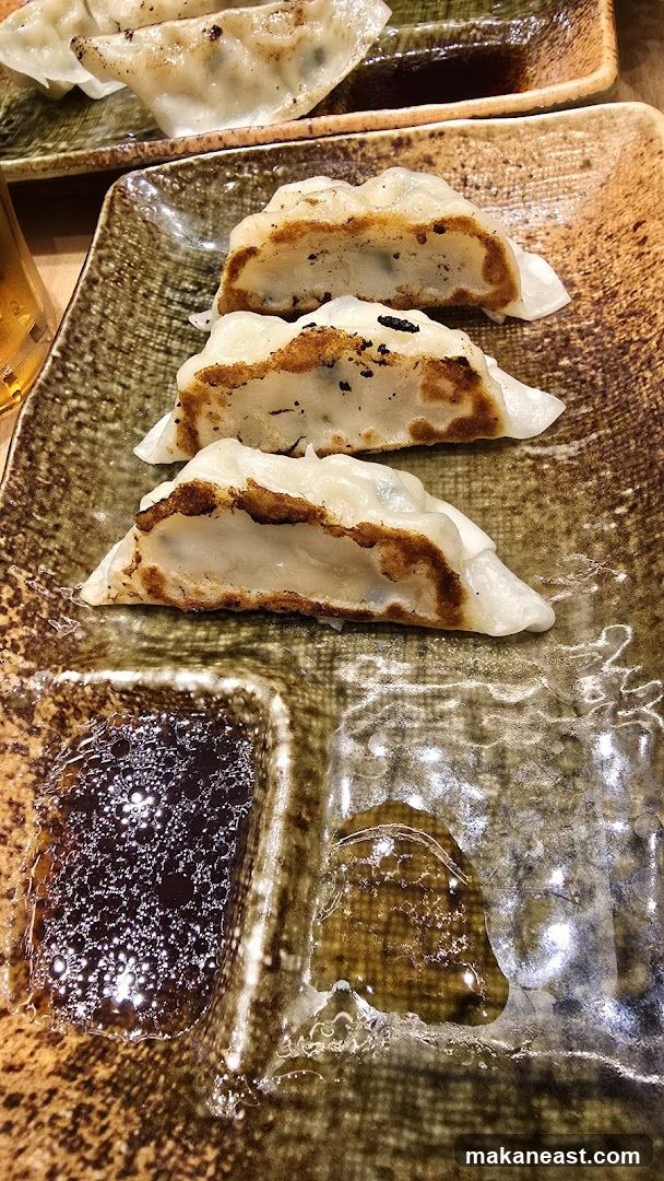 Pan-fried dumplings with dipping sauce