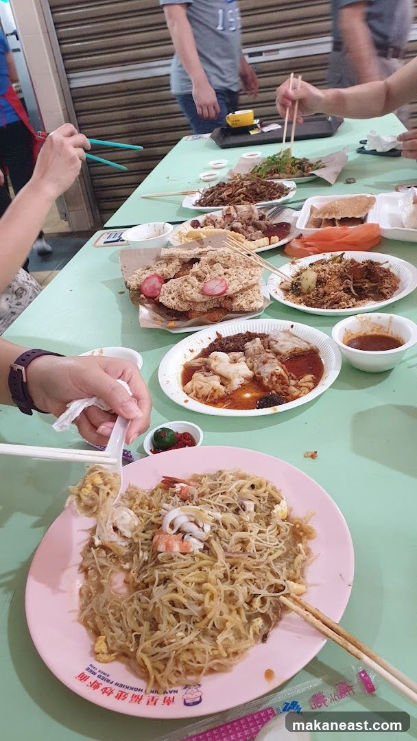 People eating at a food stall