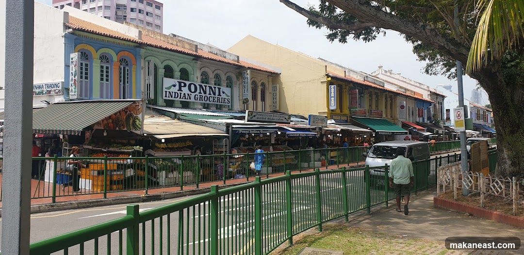 Street view of Indian groceries and fruit stalls