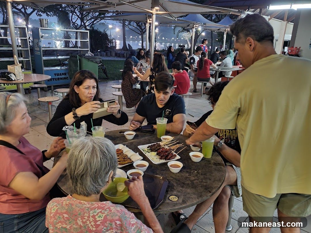 People eating at an outdoor food court