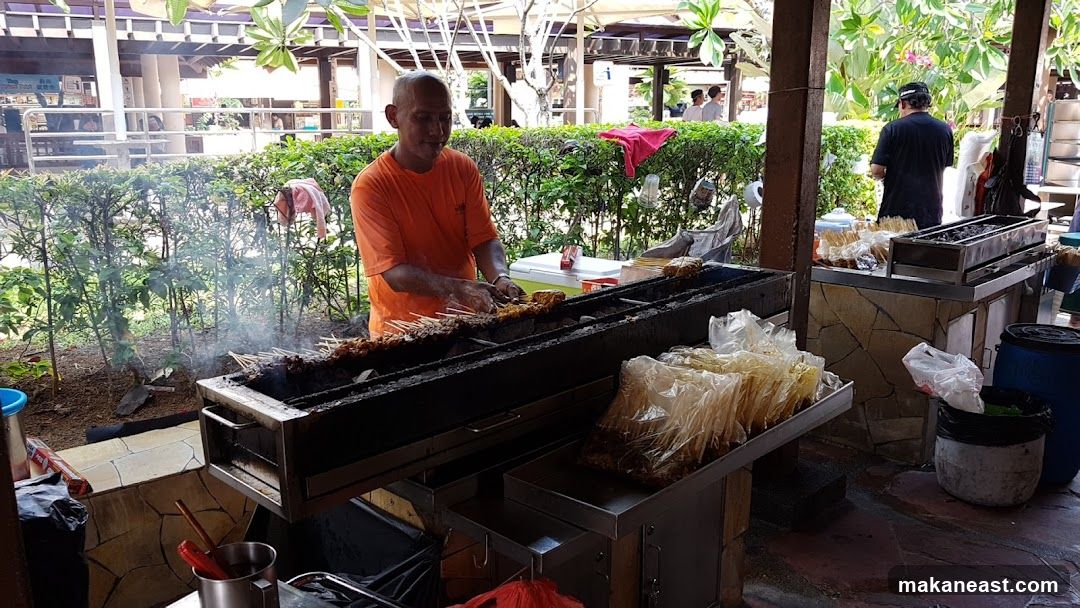Street Food Vendor Grilling Skewers