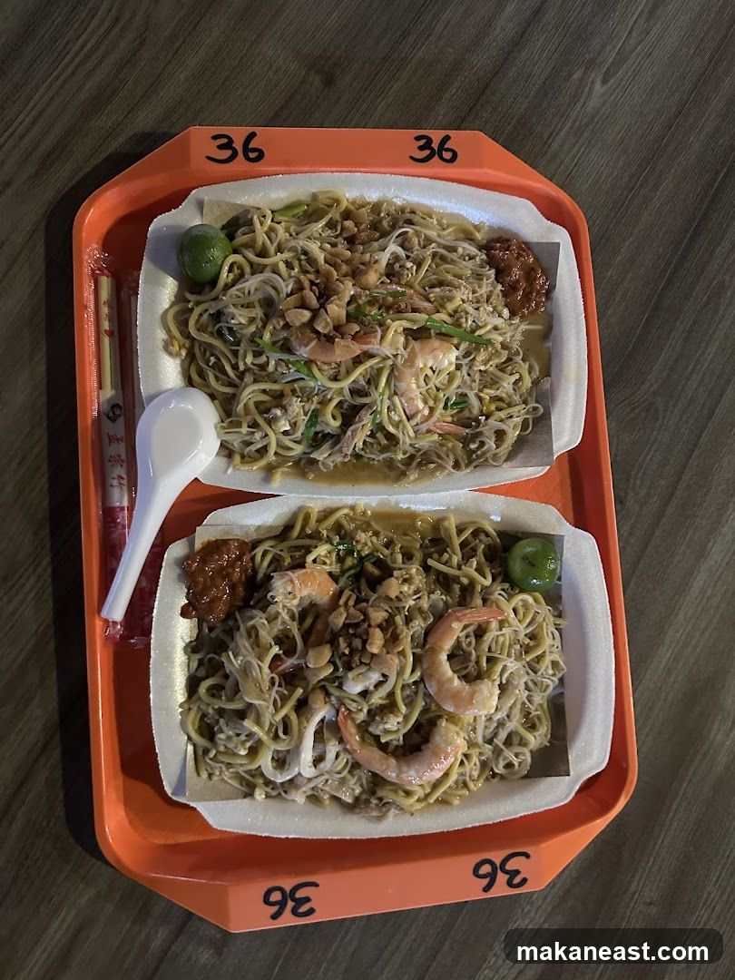 Two plates of noodles with shrimp