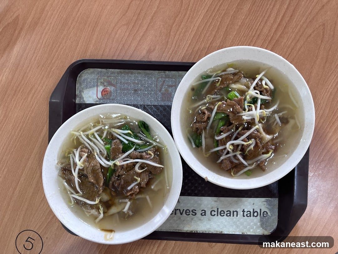 Two bowls of beef noodle soup