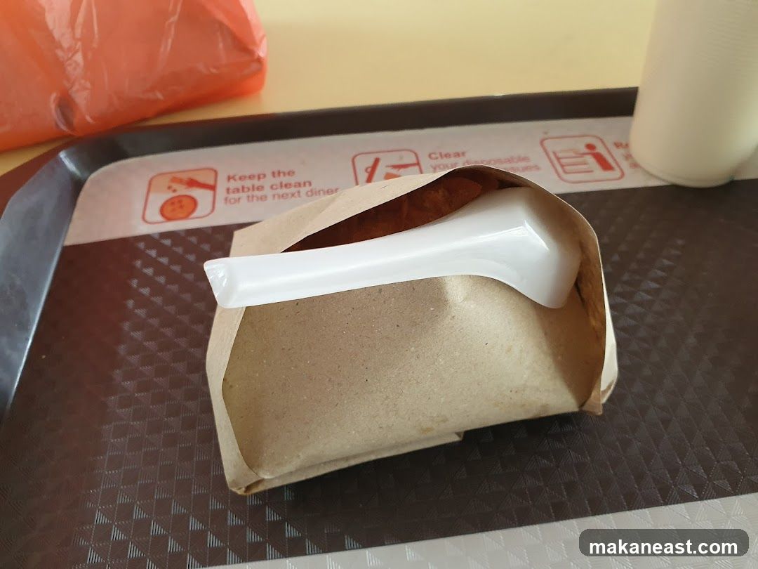 Food Wrapped in Paper with Spoon