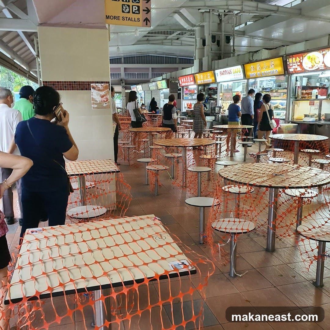 Food court with tables covered in orange netting
