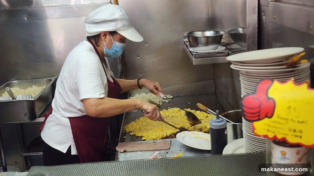 Cook preparing food on a griddle