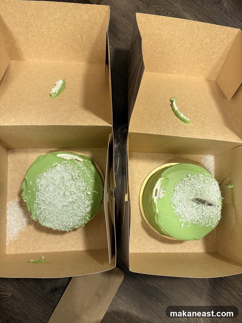 Two green cakes in boxes