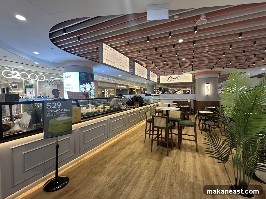Interior of a cafe with cakes and seating