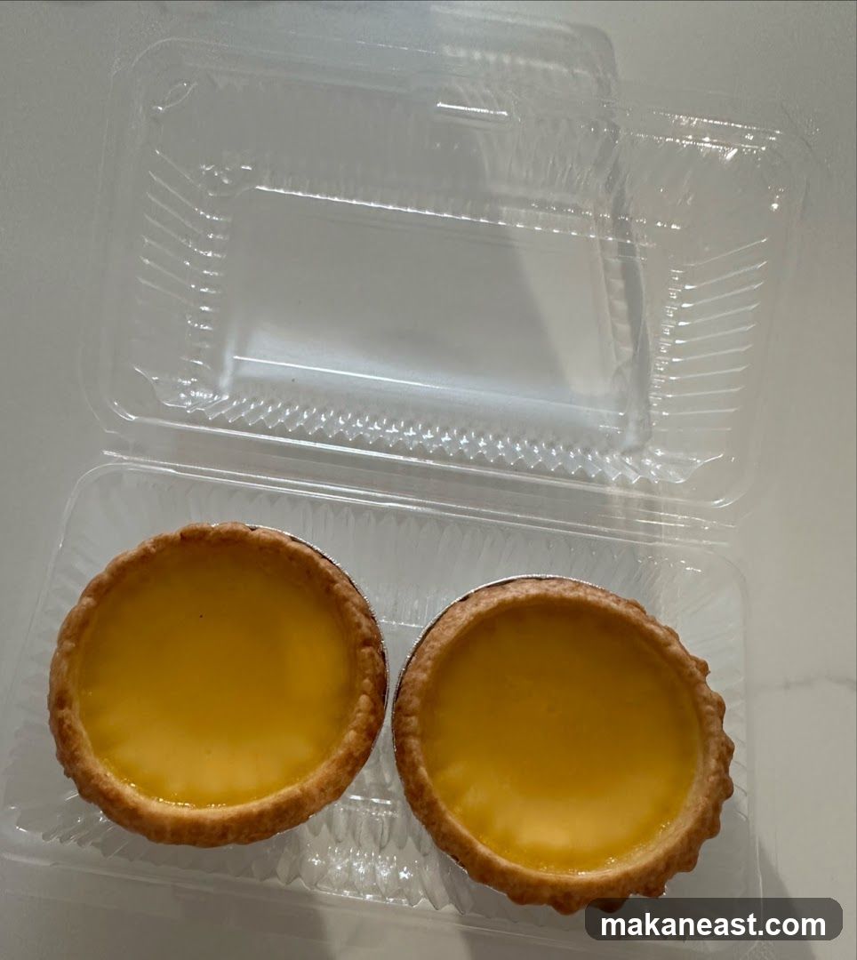 Two Egg Tarts in a Plastic Container