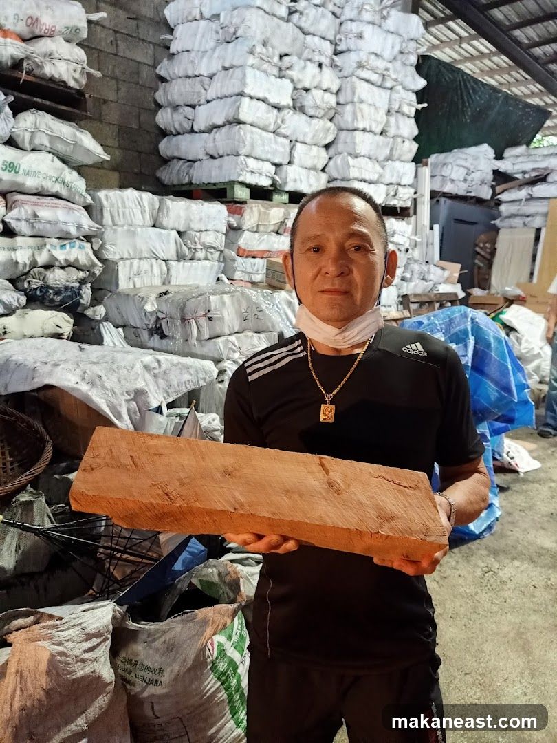 Man Holding a Piece of Wood