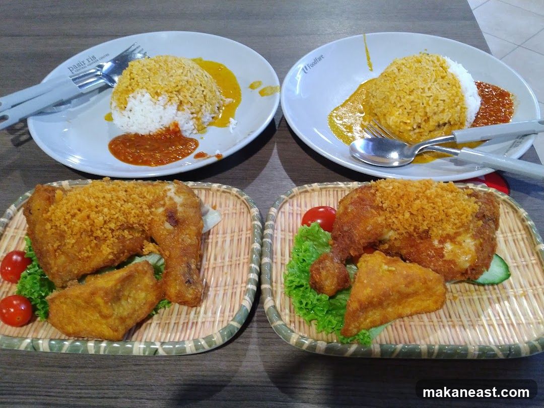 Two plates of fried chicken with rice