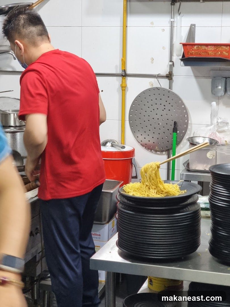 Cook preparing noodles