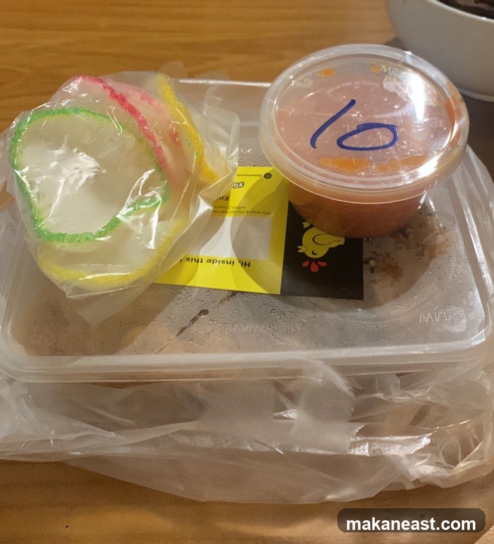 Takeaway Food Container with Prawn Crackers and Sauce