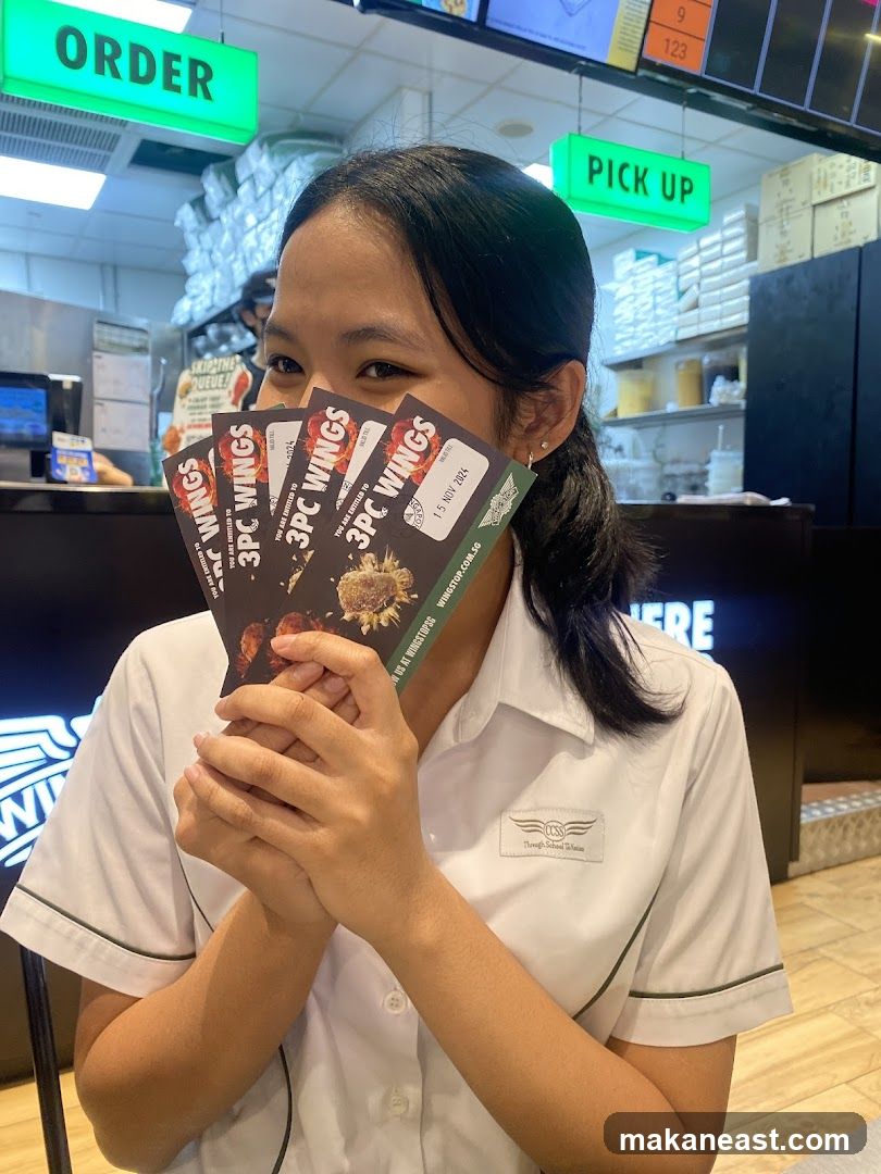 Woman holding wing coupons